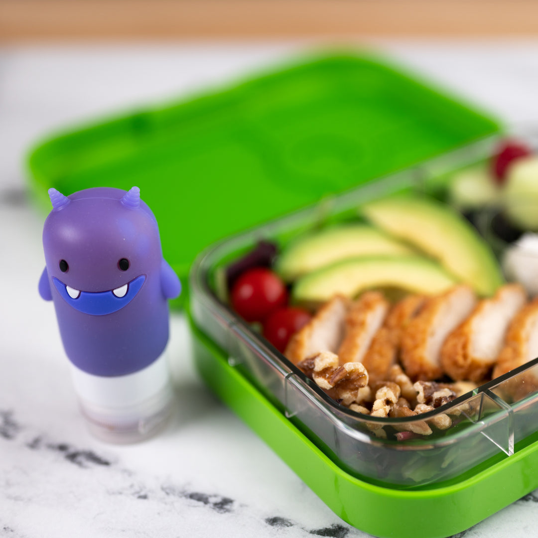 https://yumboxlunch.com/cdn/shop/products/yumbox-photo-square-2021-funny-monster-squeeze-action-02.jpg?v=1610558630&width=1080